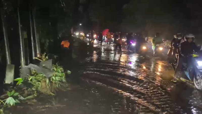 Petugas gabungan TNI, Polri, dan BPBD membersihkan material longsoran. 