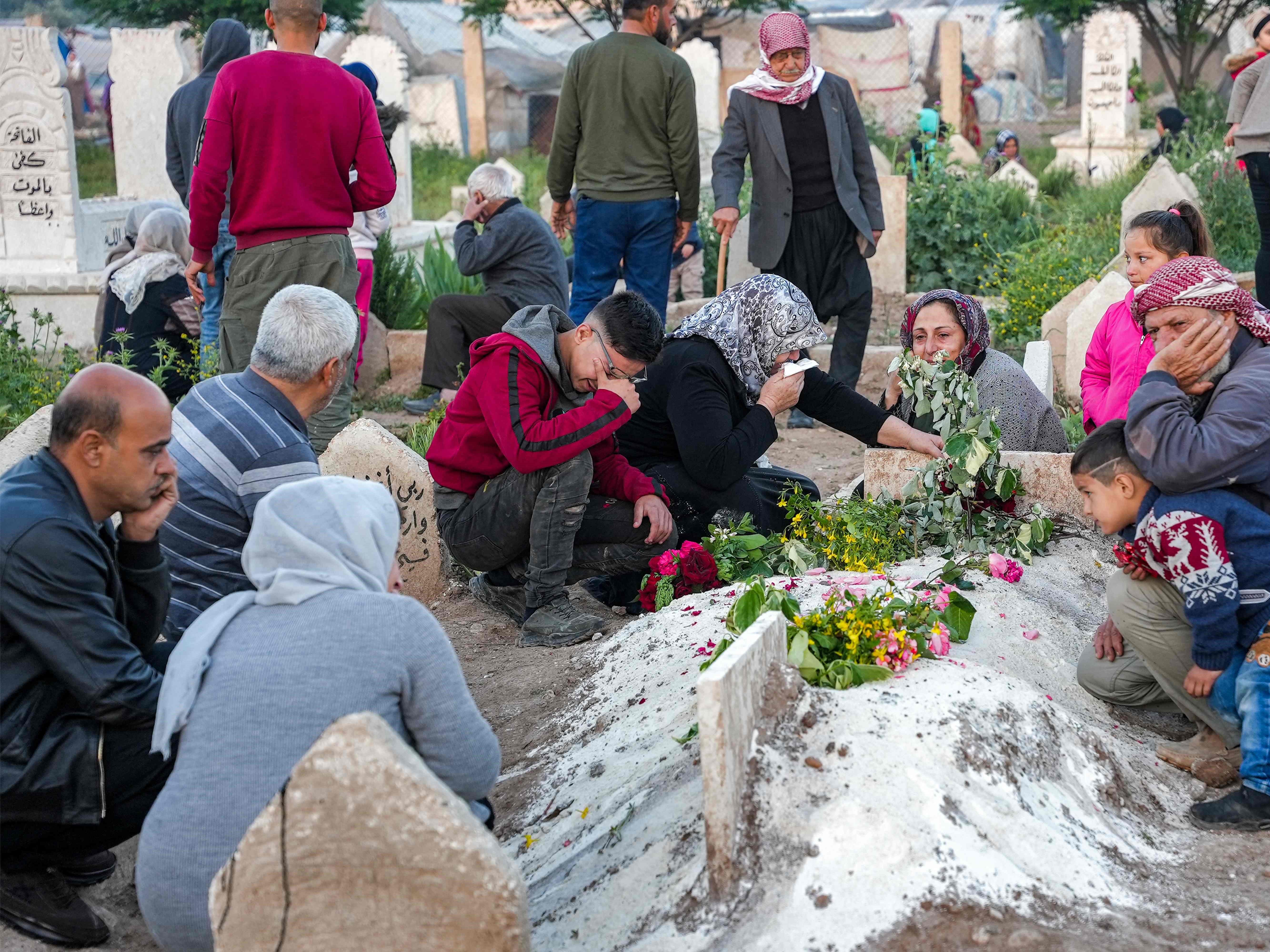 Warga Suriah mengunjungi makam orang yang dicintai pada hari pertama Idul Fitri, yang menandai akhir Ramadan.
