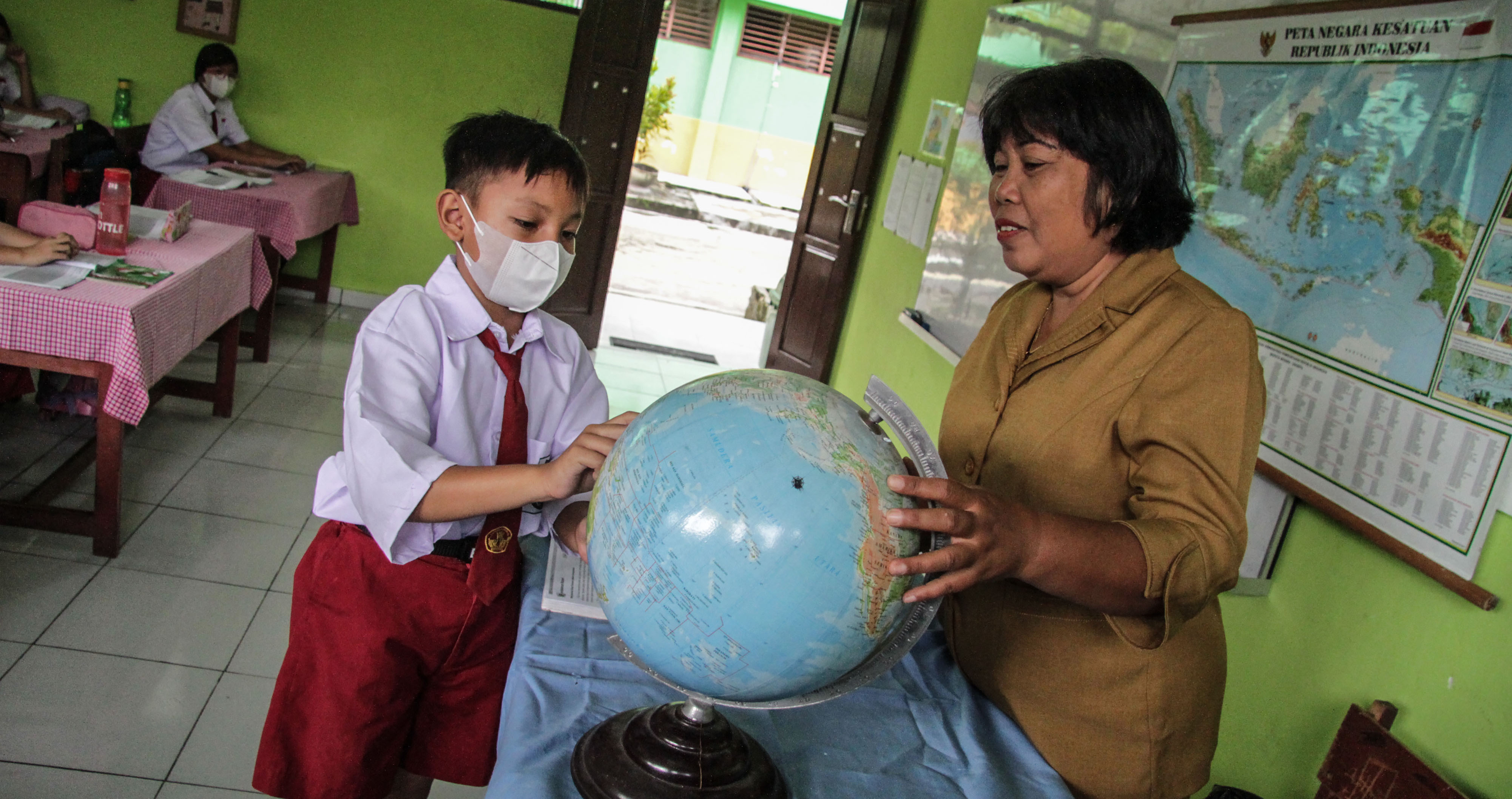 Seorang guru berinteraksi dengan siswa pada kegiatan belajar mengajar di SDN Langkai 11 Palangka Raya, Kalimantan Tengah.