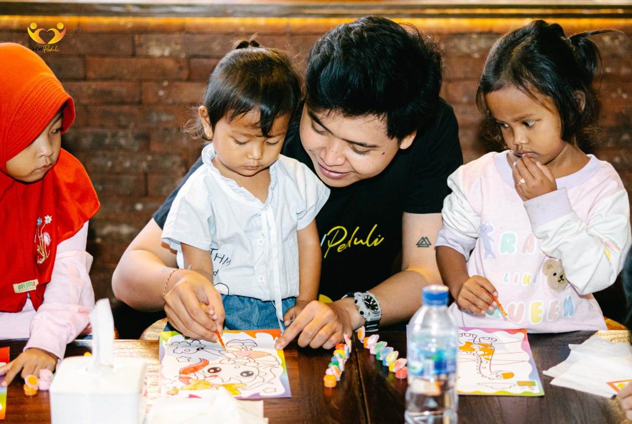 Staf HRW Group mendampingi anak-anak mewarnai gambar dalam kegiatan sosial di Kota Bekasi, Jawa Barat.   