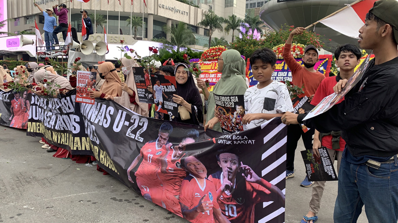 Ratusan warga ibu kota membawa bunga mawar dan poster menyambut kedatangan timnas U-22 yang diarak.