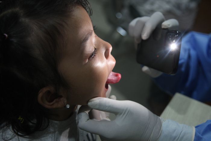 Pasien dengan gejala batuk dan sesak nafas antre memeriksakan diri di Poli Batuk dan ISPA di Puskesmas Cilincing