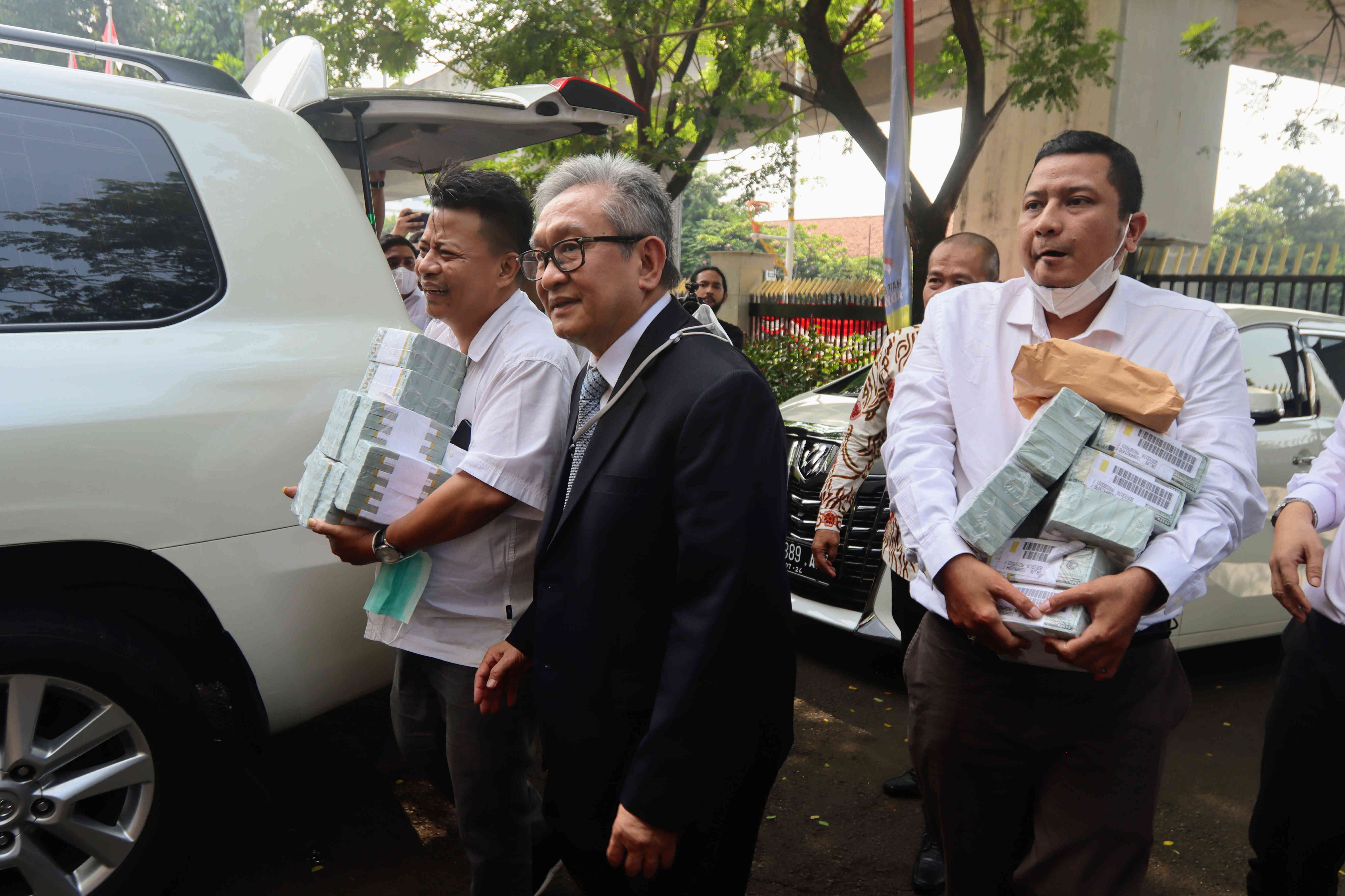 Maqdir Ismail (jas hitam) pengacara dari Irwan Hermawan dalam kasus korupsi BTS Bakti Kominfo, membawa uang sebesar Rp 27 miliar ke Kejagung