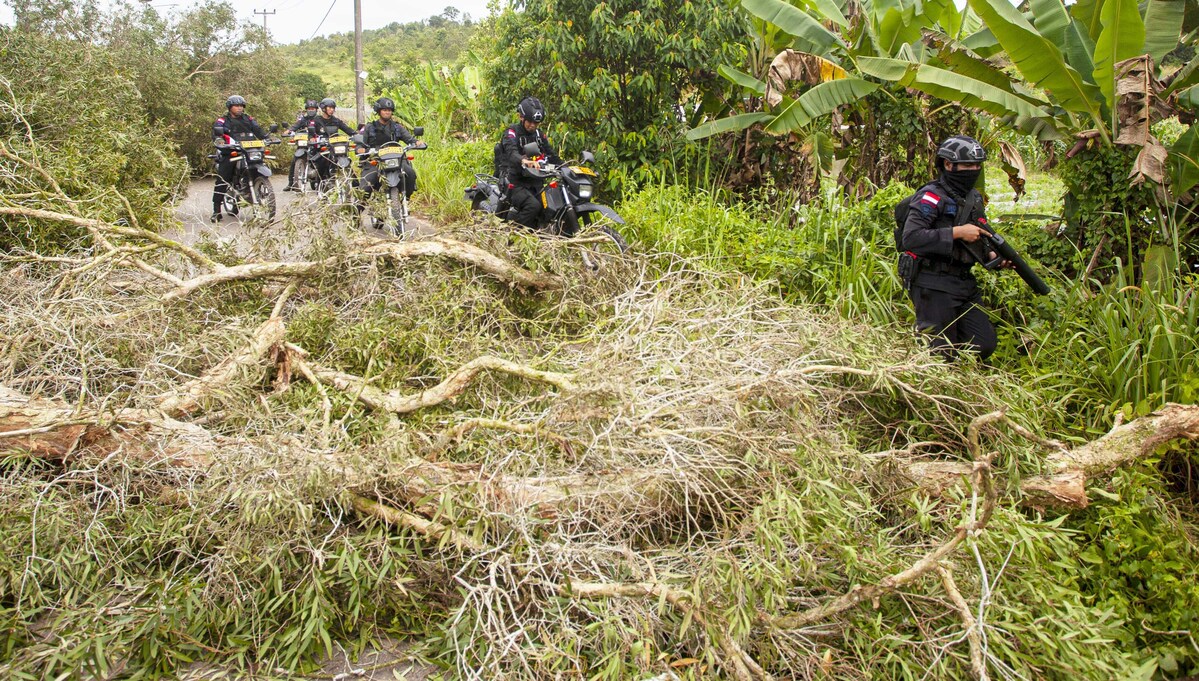 Sejumlah anggota Brimob Polda Kepri menyisir jalan yang diblokir oleh warga Pulau Rempang, Batam, Kepulauan Riau.