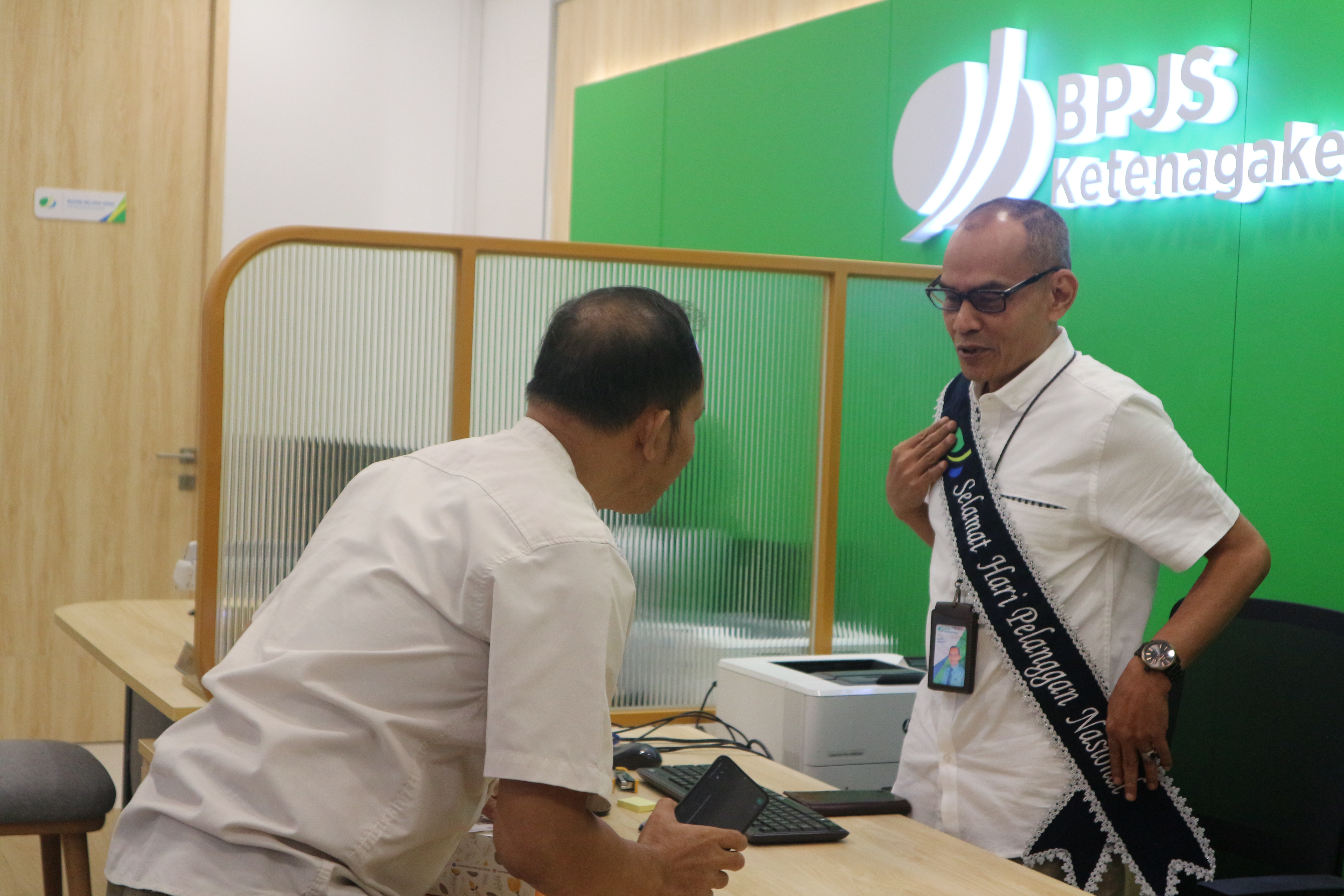 Kepala Kantor Cabang BPJAMSOSTEK Jakarta Kebayoran Baru Husaini menyapa pelanggan atau peserta bersamaan peringatan Harpelnas 2023.