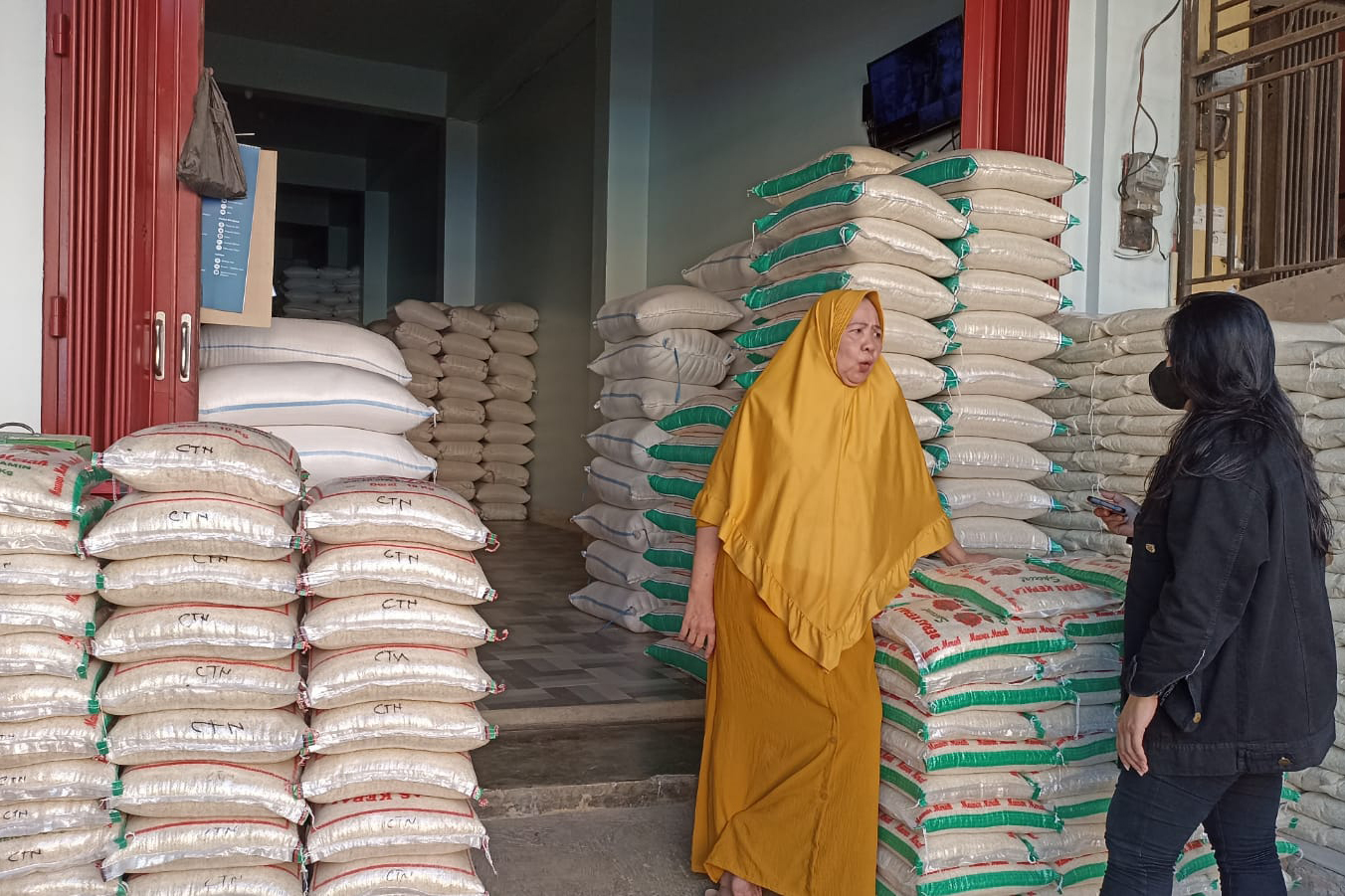 Pedagang beras berbincang dengan konsumen di Palu, Sulawesi Tengah, Rabu (13/9).