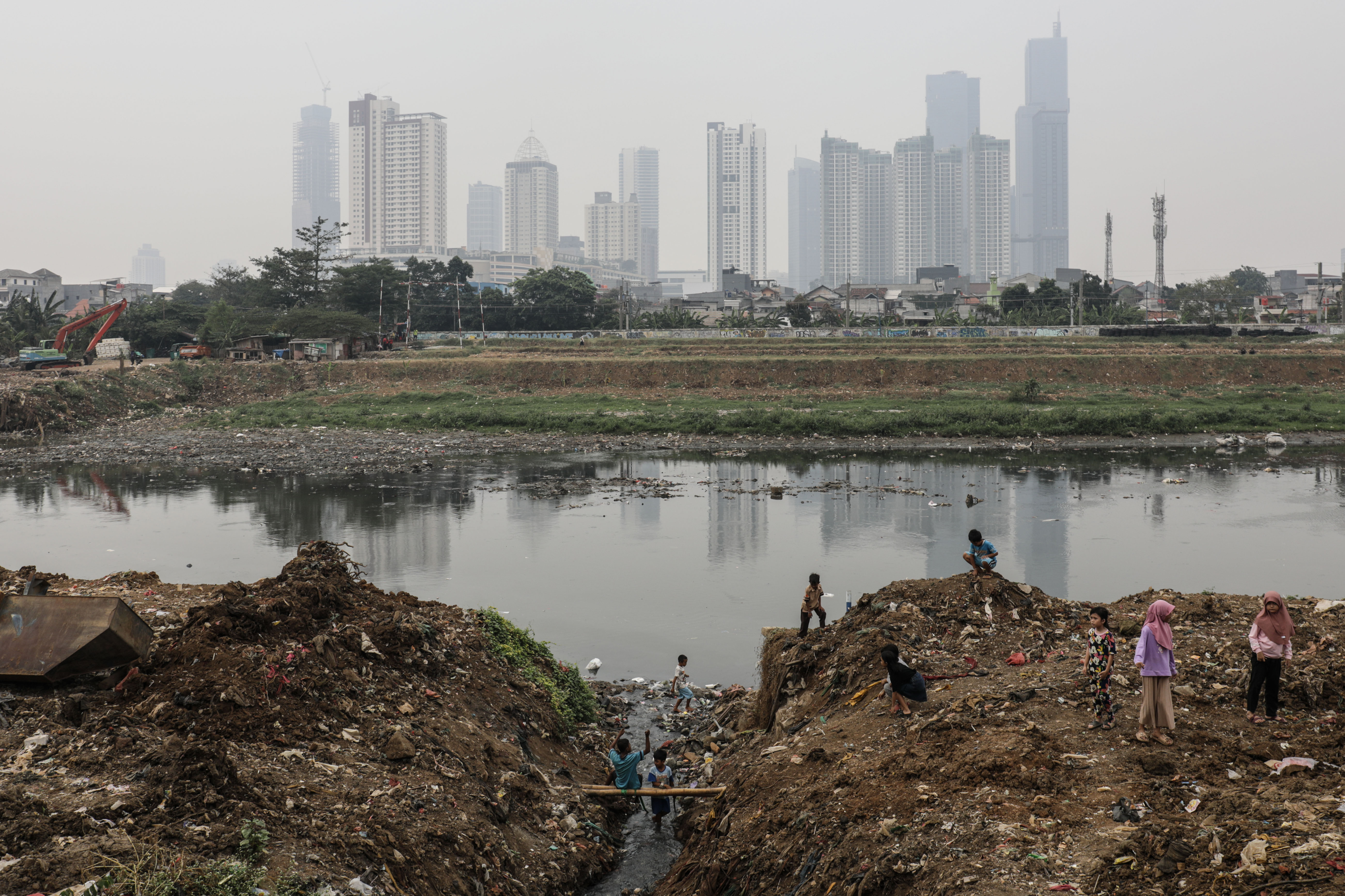 Anak-anak bermain di tepi aliran sungai Kanal Banjir Barat (KBB) di kawasan Petamburan, Tanah Abang, Jakarta Pusat.