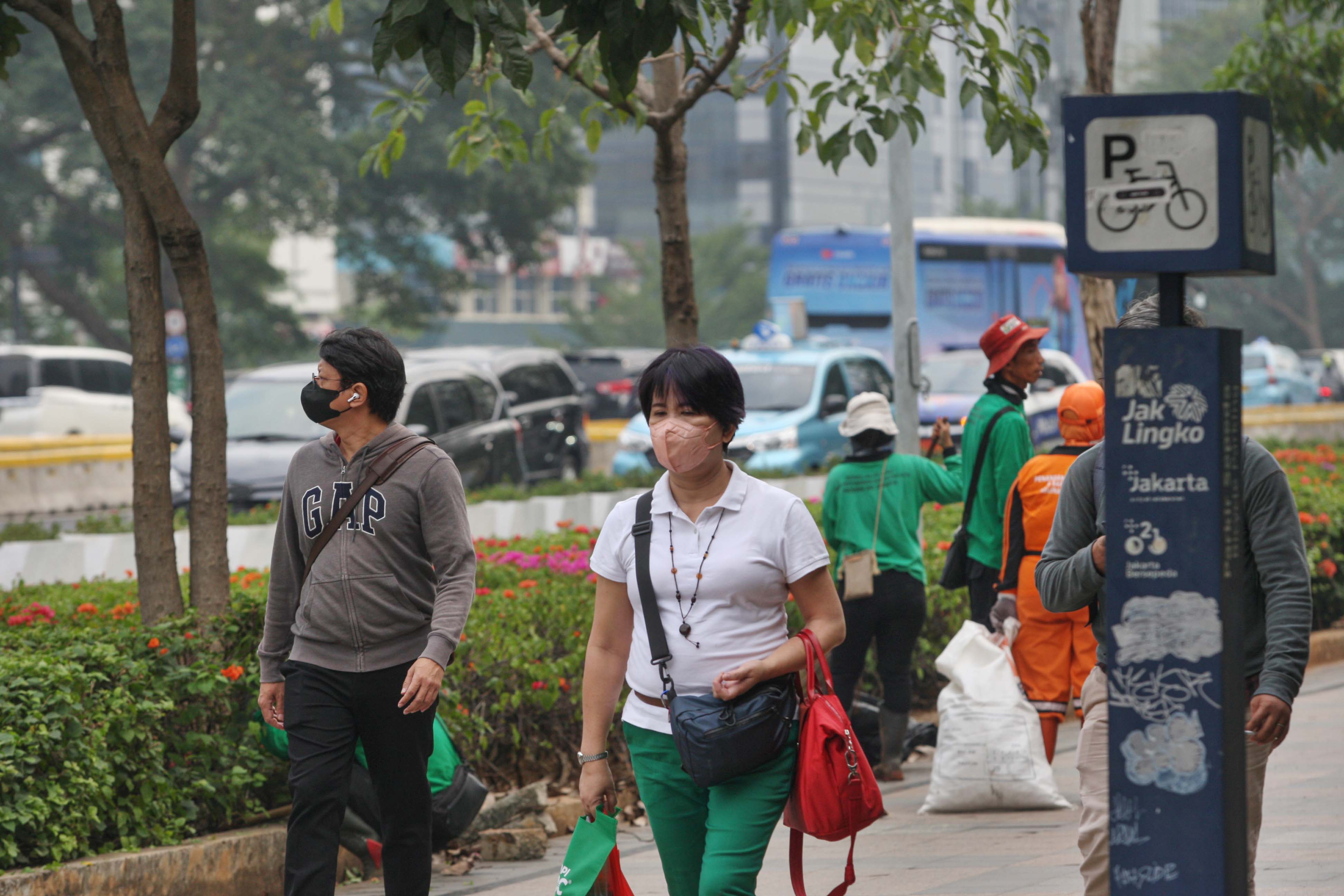 Warga menggunakan masker saat beraktivitas untyuk menghindari paparan polusi udara di Jakarta