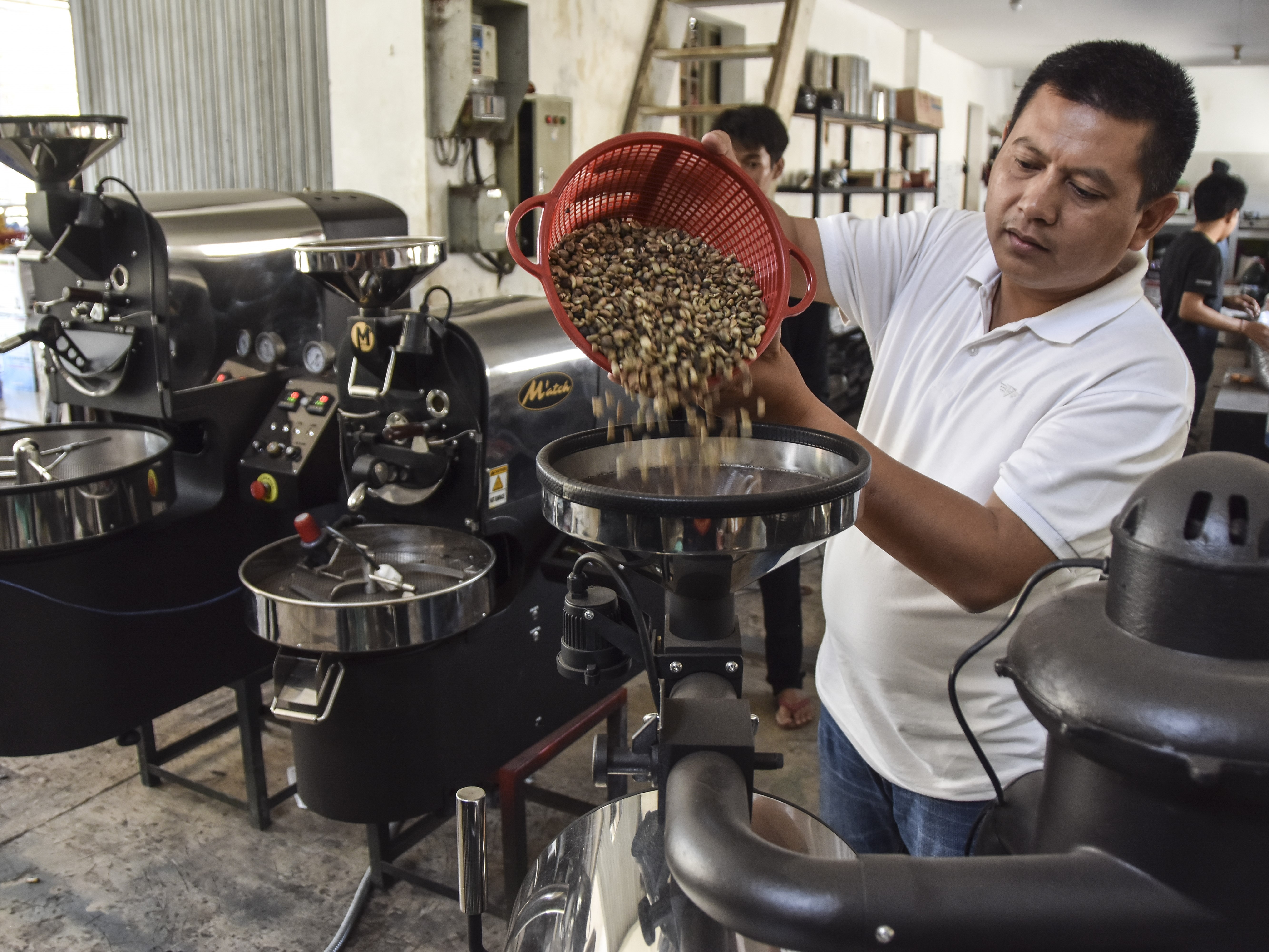 Perajin Emin Muhaemin mengoperasikan mesin roasting kopi di industri rumahan Match, Desa Sukajaya, Kecamatan Rajadesa, Kabupaten Ciamis.