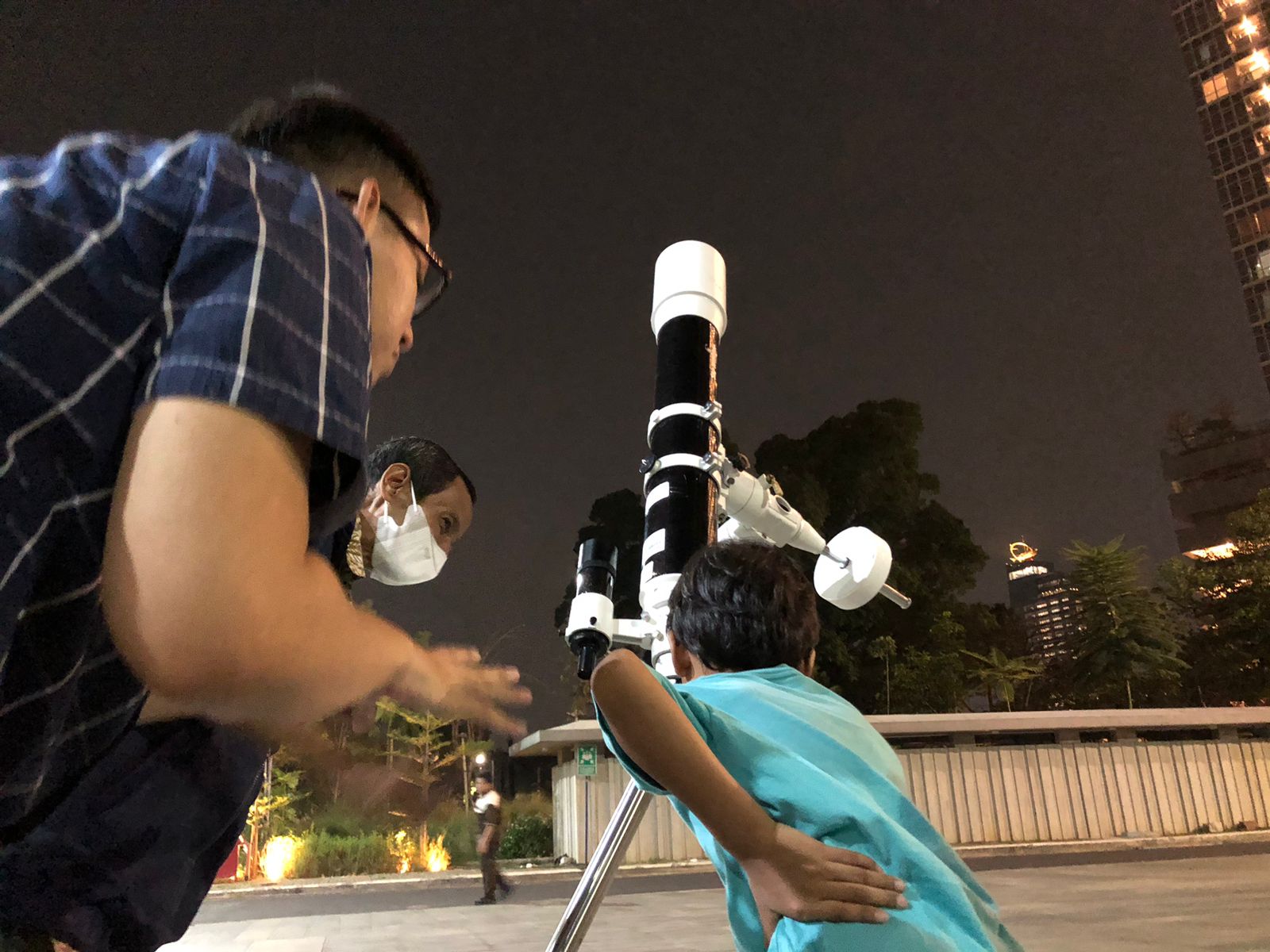 Seorang anak mencoba melihat benda langit melalui teropong di Taman Ismail Marzuki