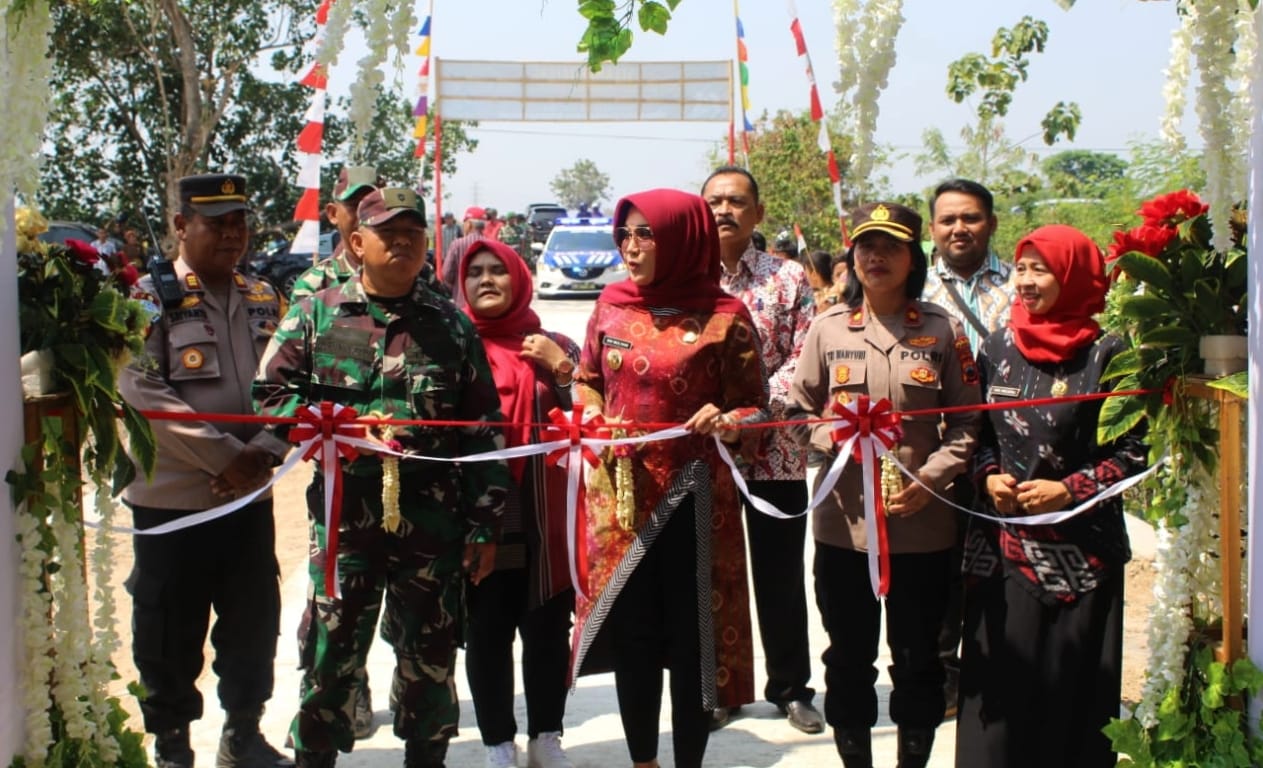 Bupati Sri Mulyani didampingi sejumlah pejabat menggunting pita dengan selesainya betonisasi jalan di Desa Boto