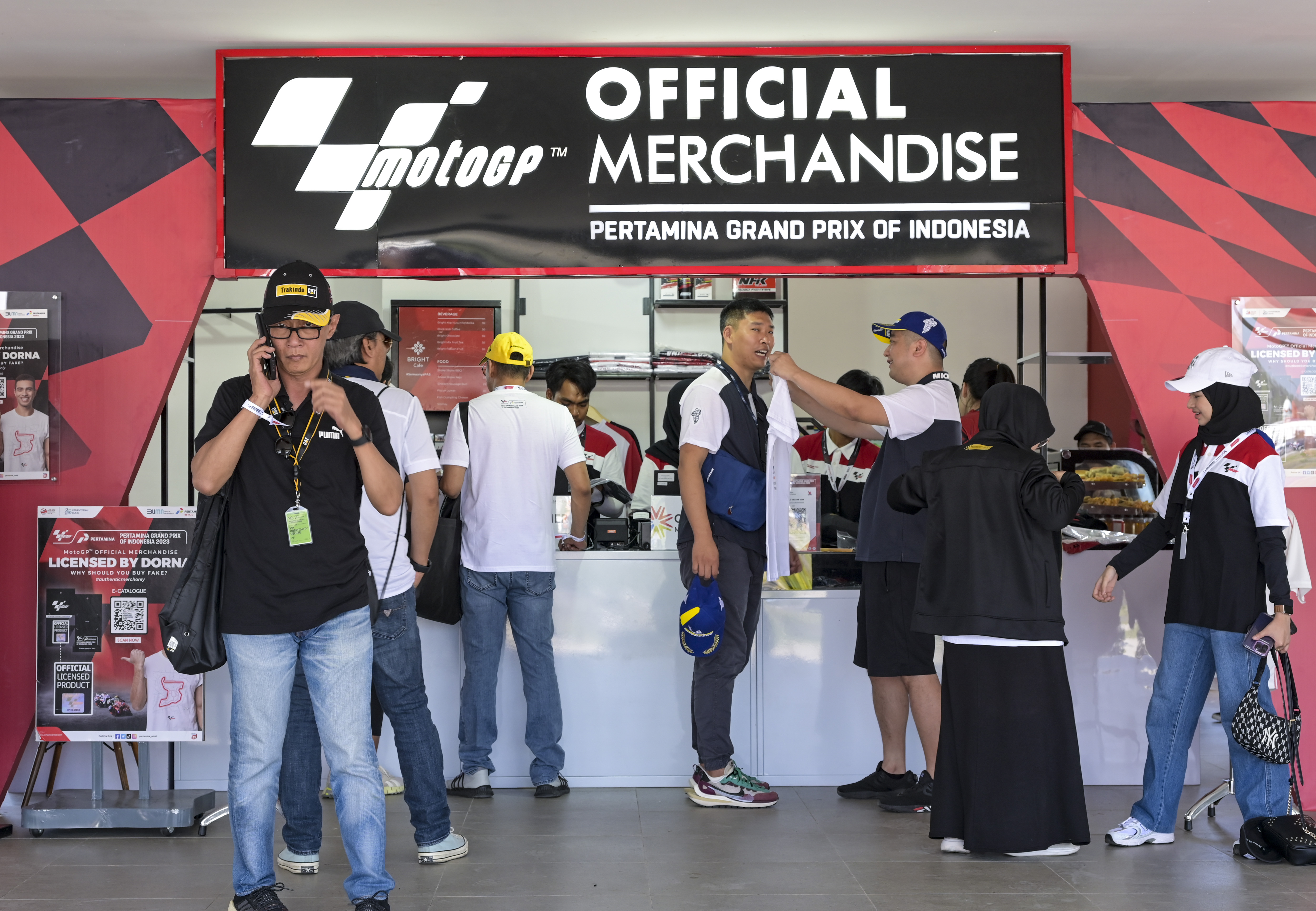 Penonton membeli pernak-pernik bertema tim pembalap Moto-GP di Sirkuit Mandalika, Lombok, NTB, Sabtu (14/10).