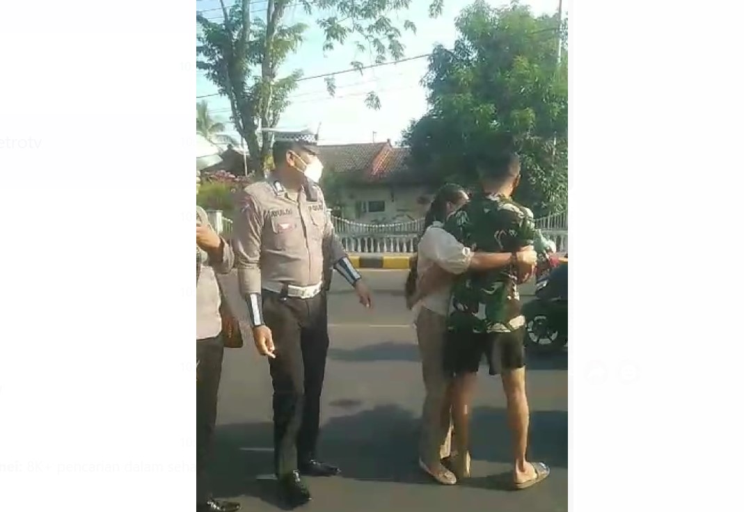 Tangkapan layar video ketika seorang pria berpakaian loreng berselisih dengan polisi karena tidak terima ditegur karena tidak pakai helm.