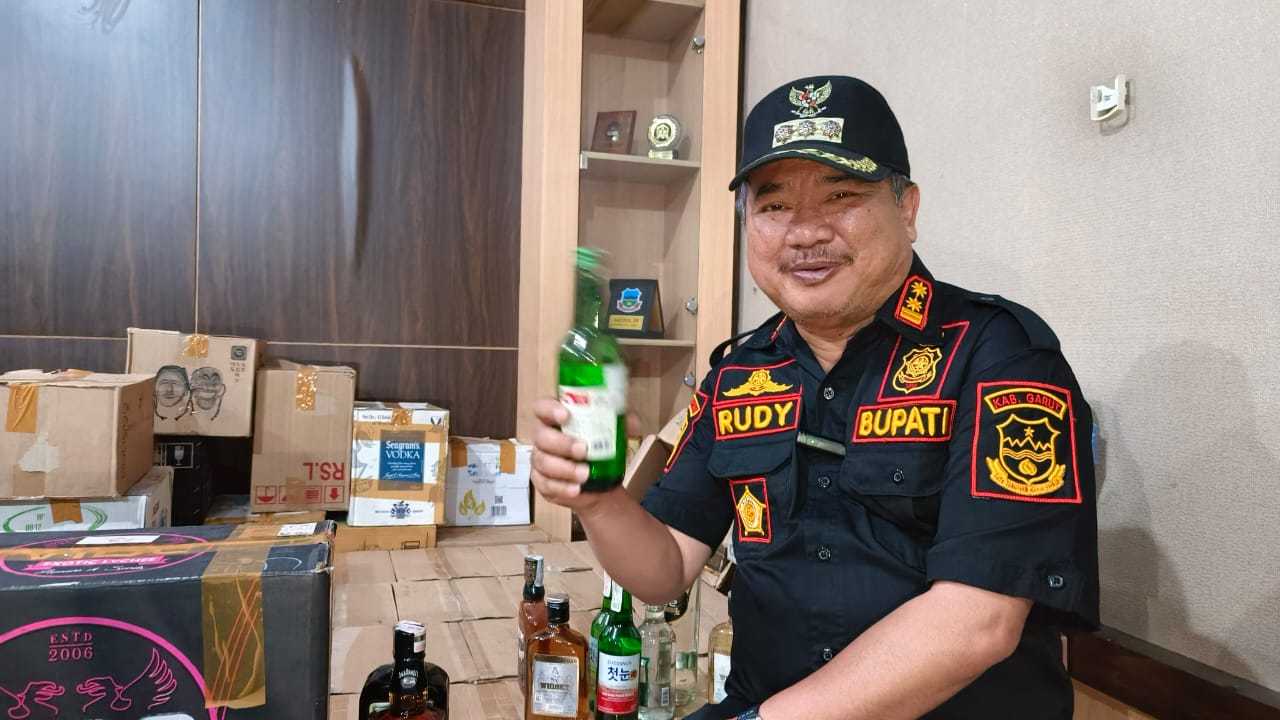 Bupati Garut Rudy Gunawan dan barang bukti minuman keras sitaan.
