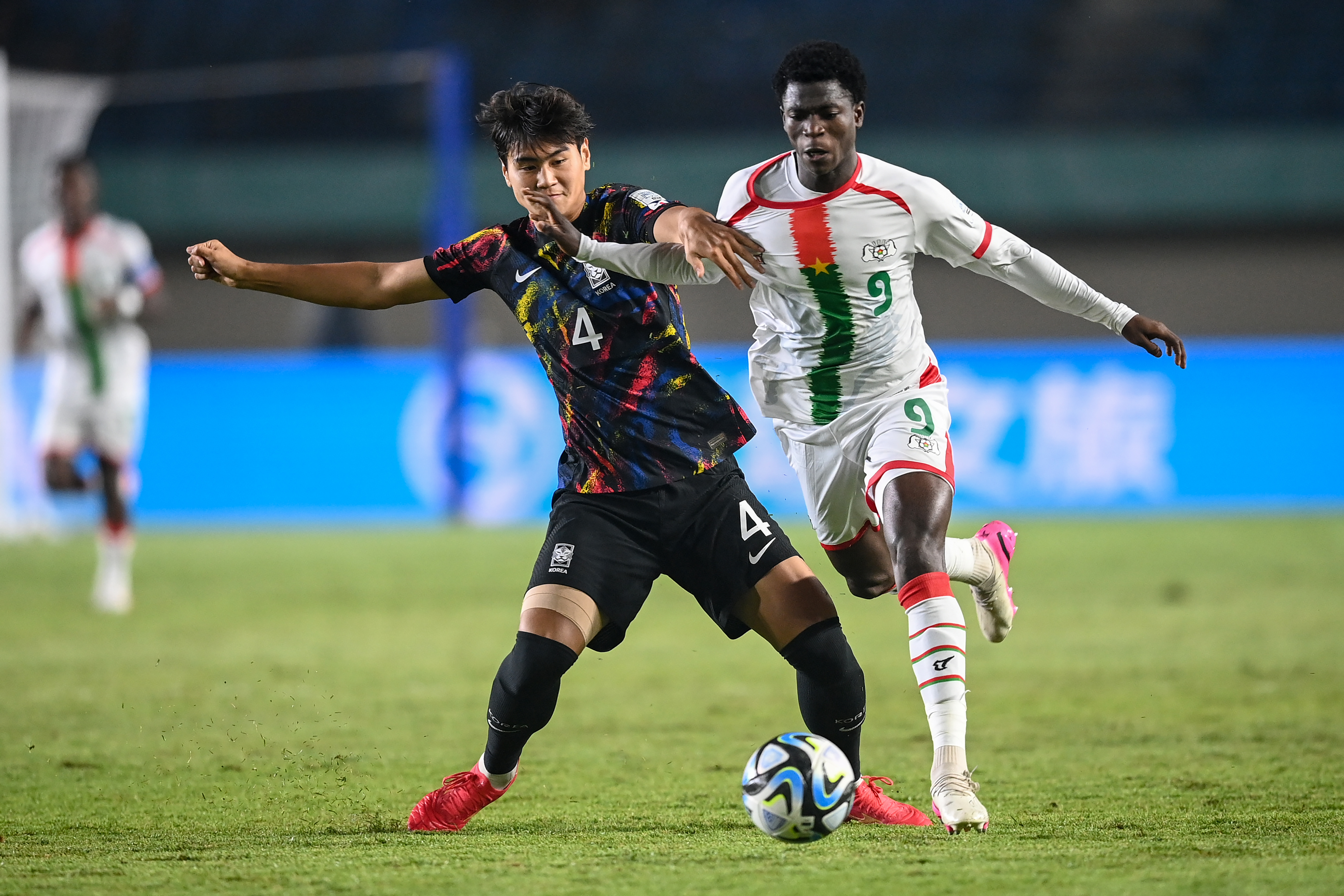 Pemain timnas Korea Selatan Minwoo Kang (kiri) berebut bola dengan pemain timnas Burkina Faso Jack Diarra (kanan).