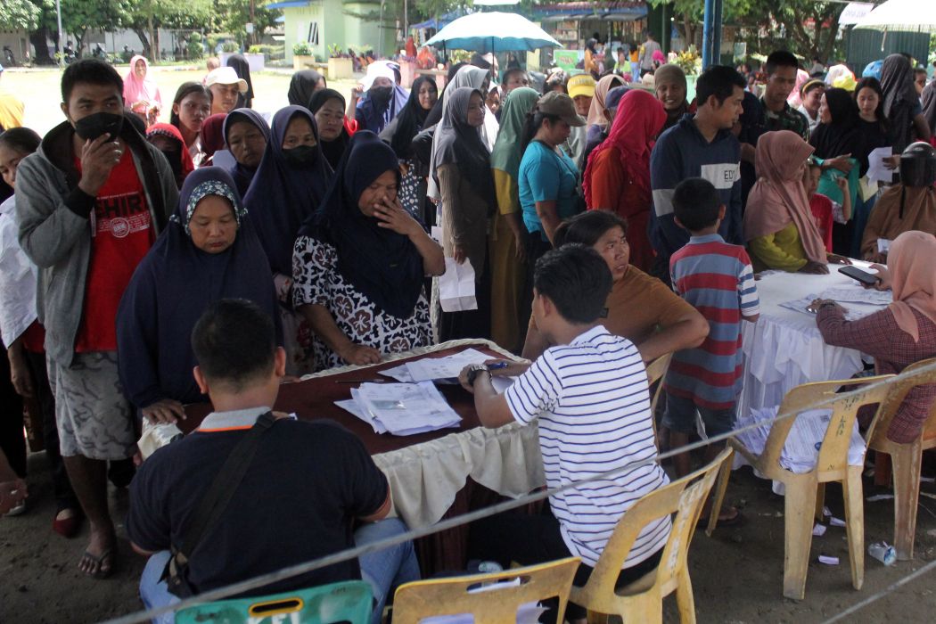 Sejumlah warga dari keluarga penerima manfaat (KPM) antre untuk mengambil Bantuan Langsung Tunai (BLT) 