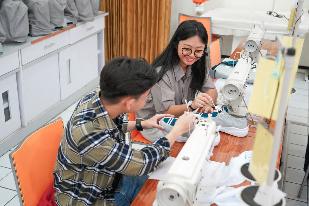 Peserta kompetisi membuat baju dengan bahan kain daur ulang.