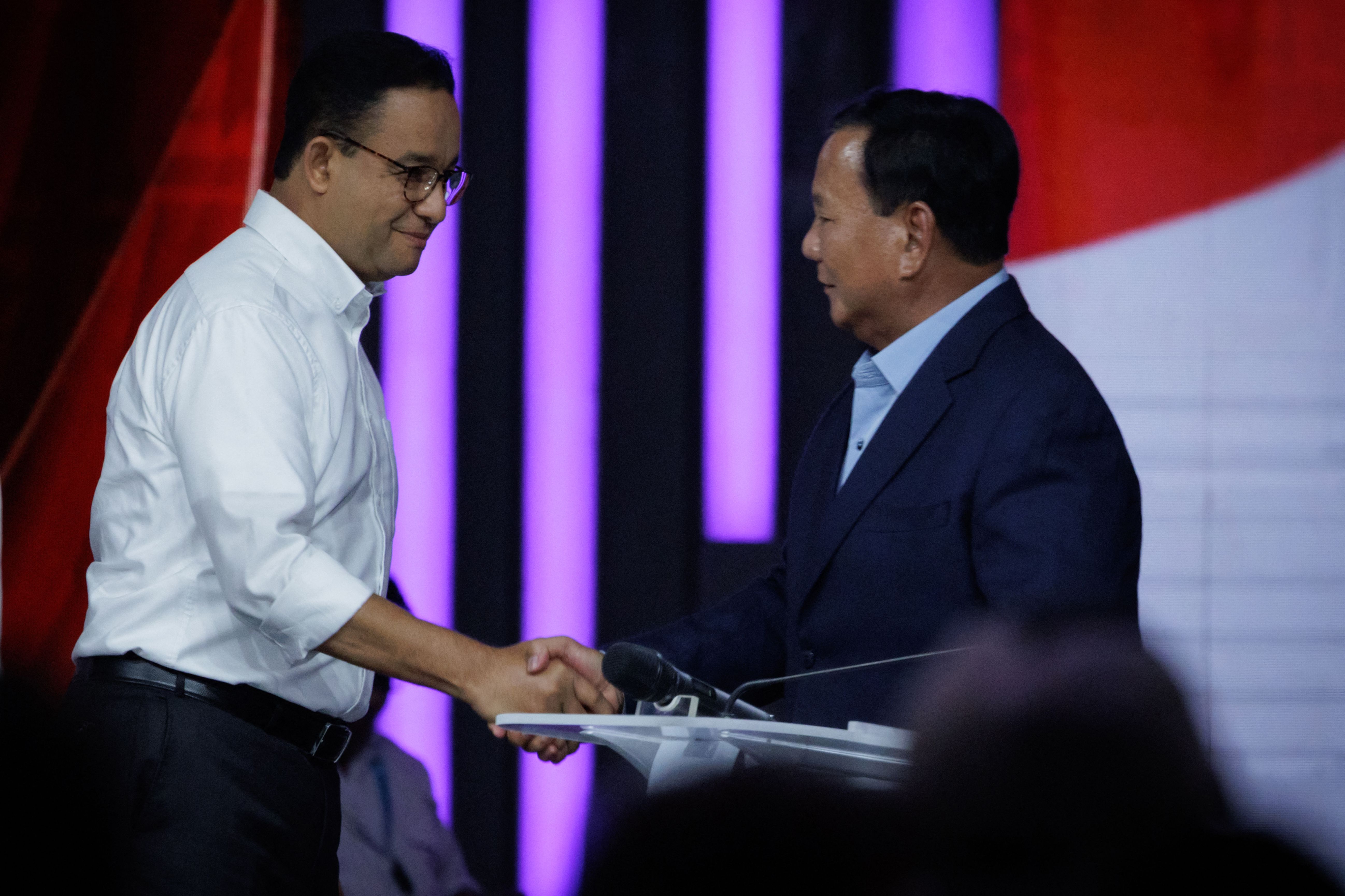 Capres nomor 01 Anies Baswedan dan nomor 02 Prabowo Subianto berjabat tangan usai debat cawapres, pada Januari 2024.