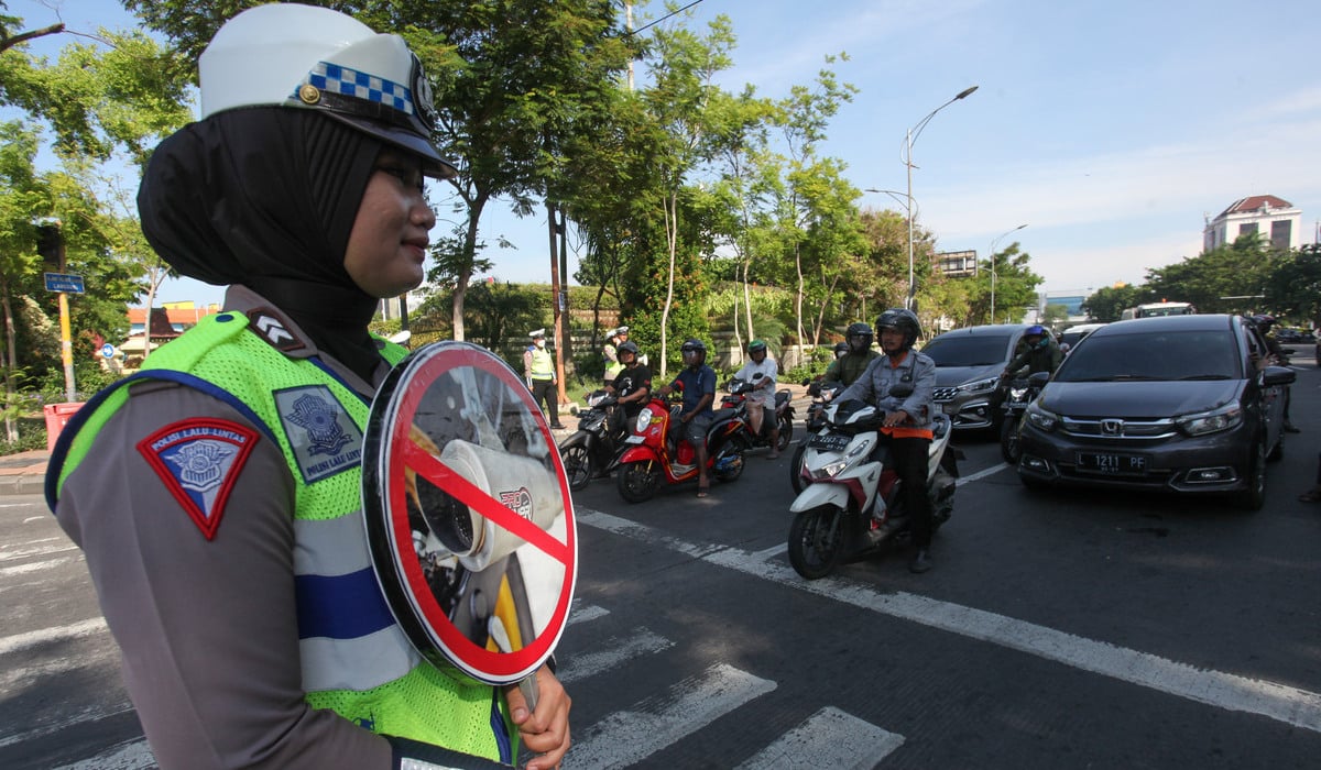 Sejumlah polisi melakukan sosialisasi larangan pemakaian knalpot brong pada kendaraan bermotor di Surabaya.