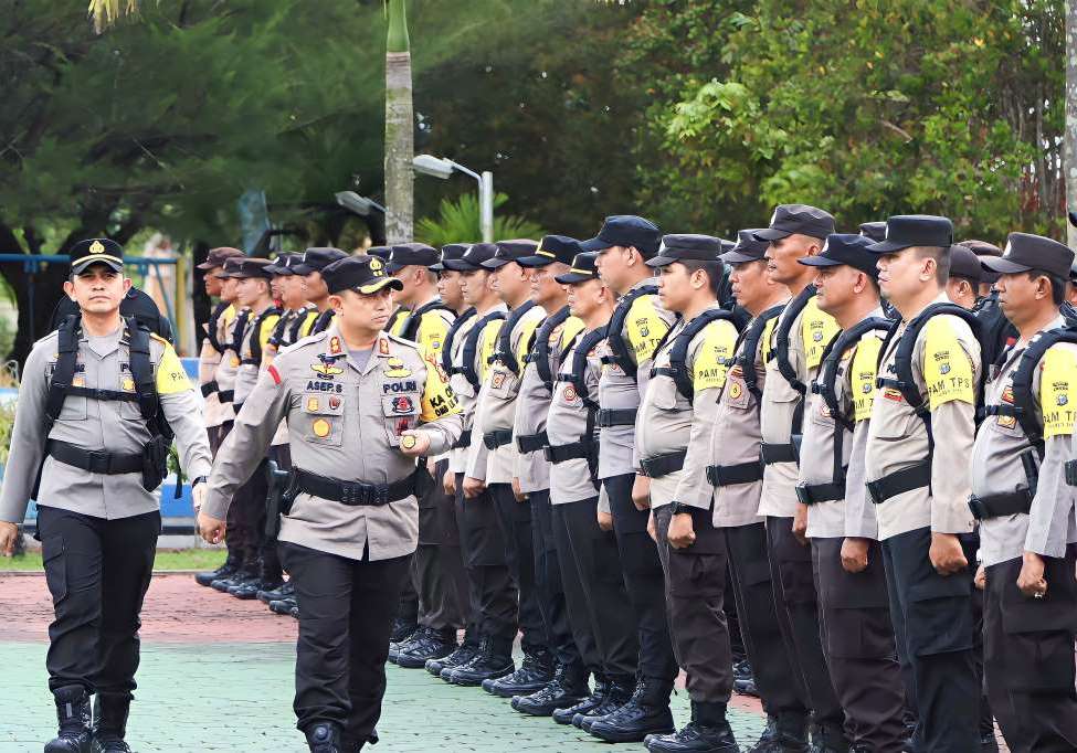 Kapolres Siak AKBP Asep Sujarwadi saat memimpin apel pengecekan personel pengamanan TPS di lapangan Mako Polres Siak, Riau, hari ini.