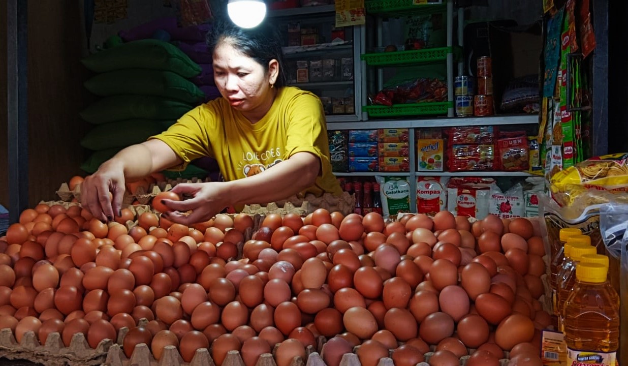 Seorang penjual telur tengah menata dagangannya