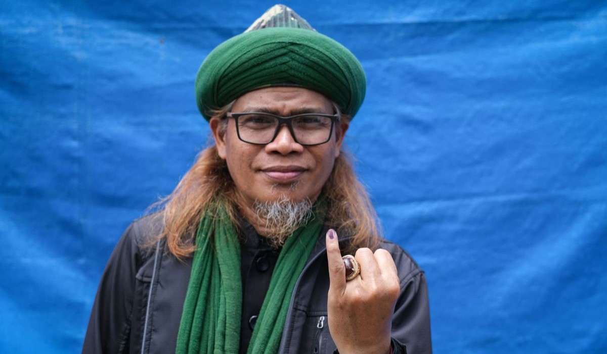 Seorang pria dari Jamaah An-Nadzir usai memberikan suaranya di tempat pemungutan suara 