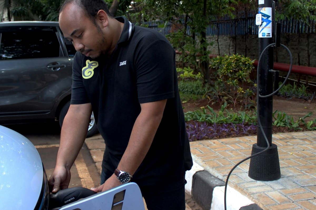 Seorang warga mengisi daya mobil listrik melalui PLN EYE di PLN Pusat Engineering Ketenagalistrikan, Jalan KS Tubun, Jakarta Barat.