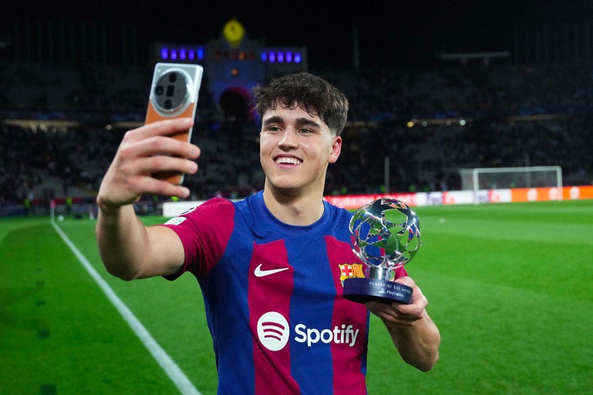 Bek tengah FC Barcelona, Pau Cubarasi sedang selebrasi dan berfoto bersama trofi MOTM miliknya usai pertandingan melawan Napoli di Liga Cham