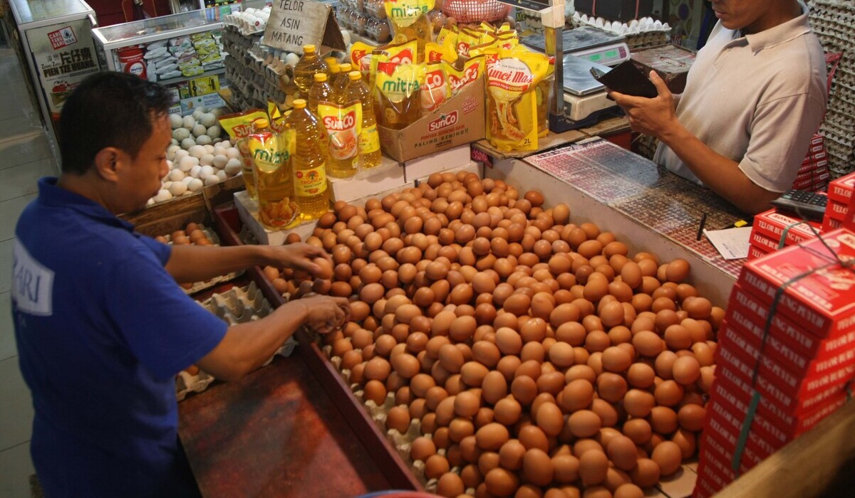 Pejual telur tengah menata dagagannya di pasar tradisional.