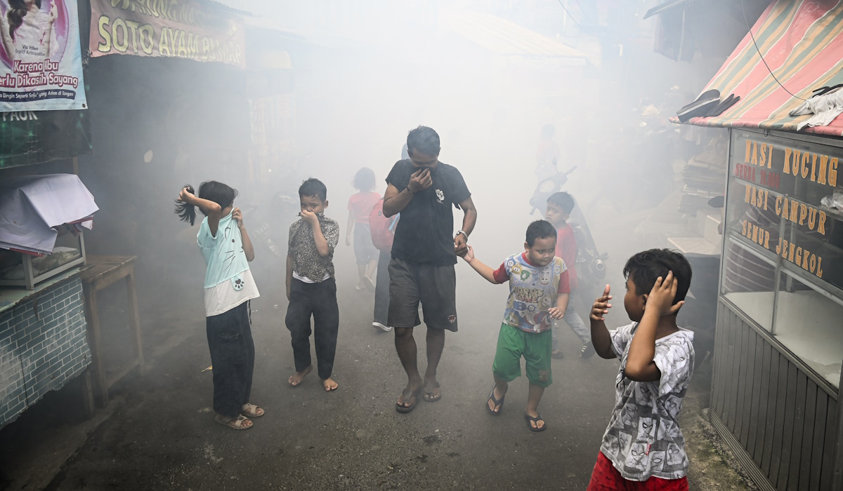 Ilustrasi: sejumlah warga berjalan saat pengasapan atau fogging 