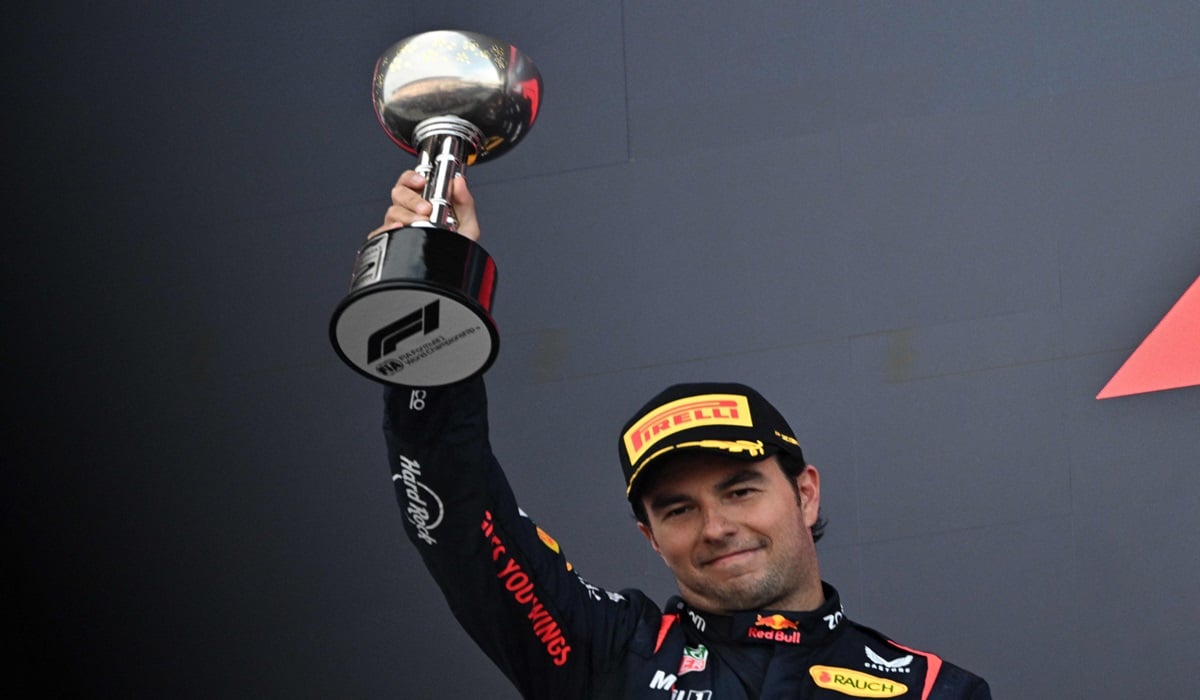 Pembalap Red Bull Sergio Perez mengangkat trofi runner-up di podium GP Jepang.