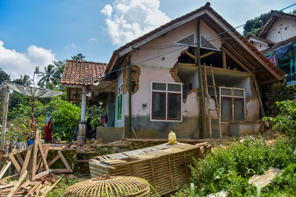 Warga membersihkan puing bangunan rumahnya yang roboh terdampak gempa di Desa Sukamulya, Kabupaten Ciamis, Jawa Barat, Minggu (28/4/2024). 