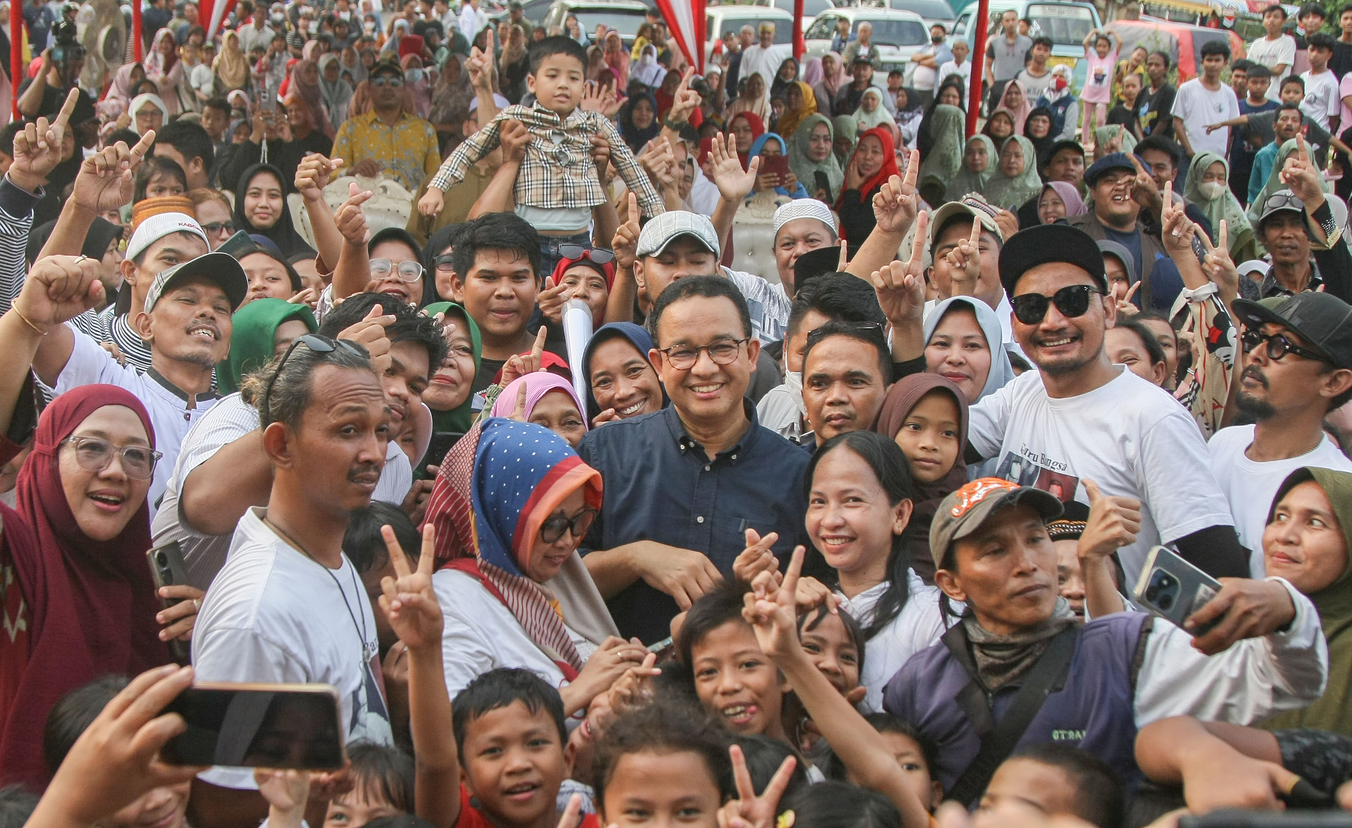 Warga berfoto dengan Mantan Gubernur DKI Anies Baswedan di Kampung Marlina, Muara Baru, Penjaringan, Jakarta Utara, Minggu (19/05/2024)