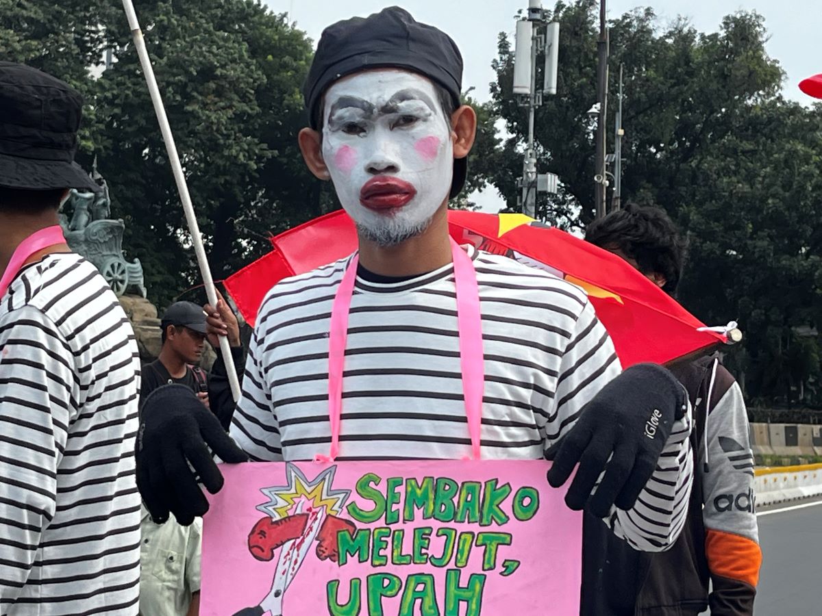 Buruh menyuarakan keresahan melalui poster di peringatan Hari Buruh 2024.