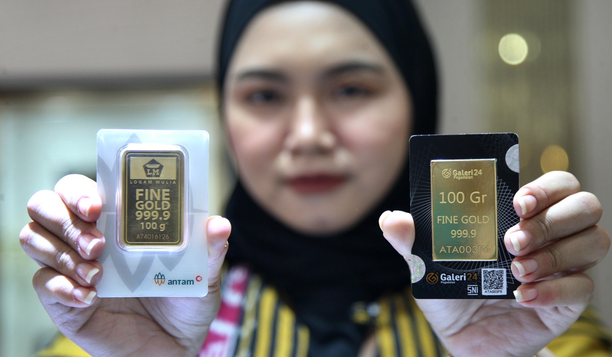  Petugas memperlihatkan emas 100 gram keluaran Antam di Pegadaian Jakarta.