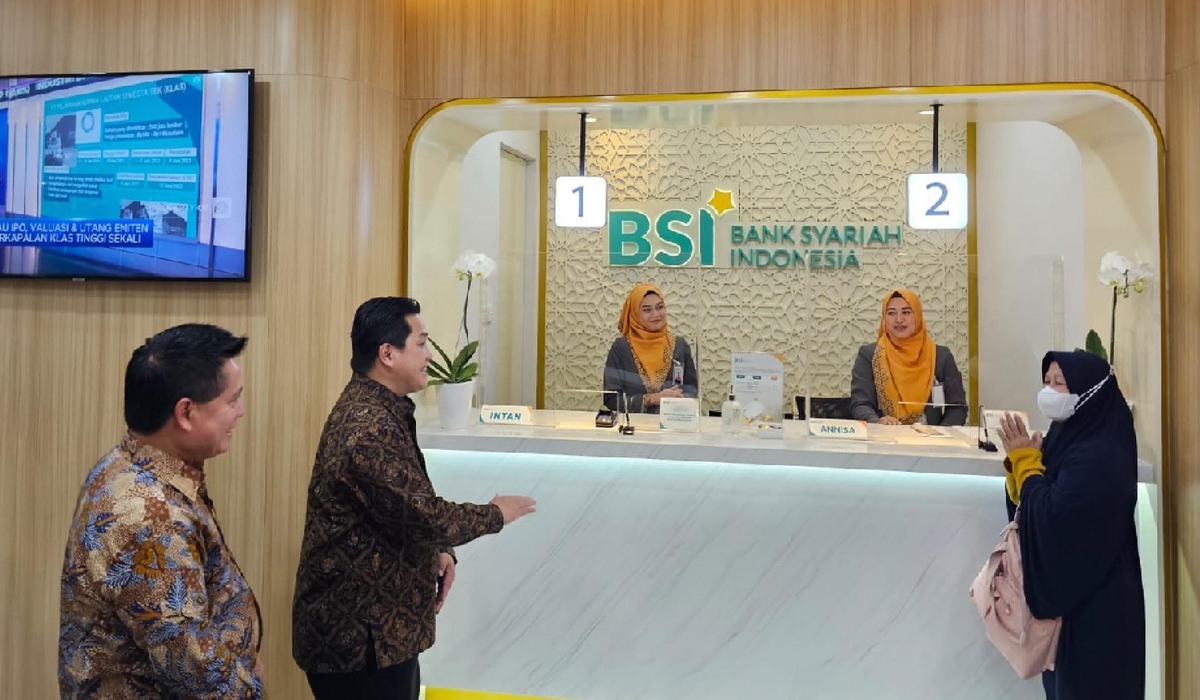 Menteri BUMN Erick Thohir (kedua kiri) bersama Direktur Utama PT Bank Syariah Indonesia Tbk (BSI) Hery Gunardi berbincang dengan nasabah.