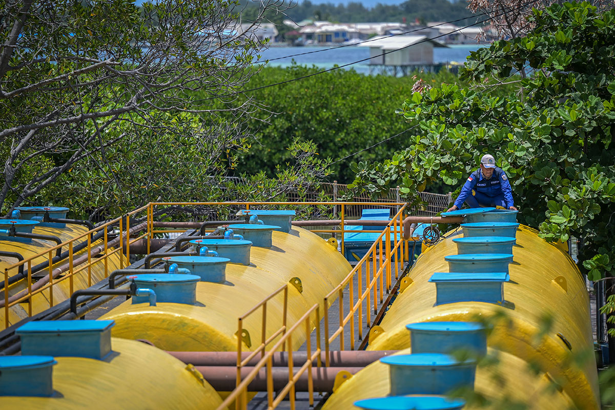 Seorang petugas Suku Dinas Sumber Daya Air mengontrol proses pengolahan air limbah dari rumah tangga.