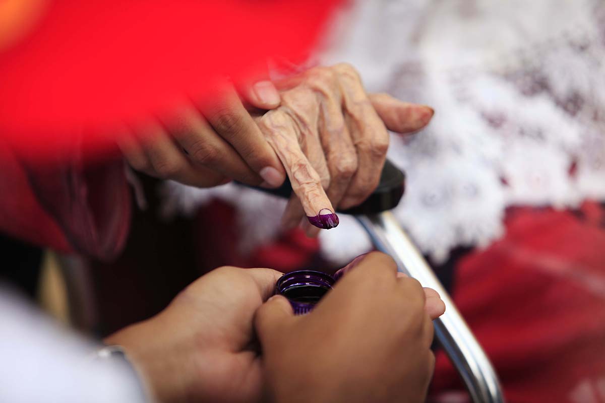 Ilustrasi. Warga mencelupkan jarinya ke botol tinga setelah menggunakan hak pilihnya.