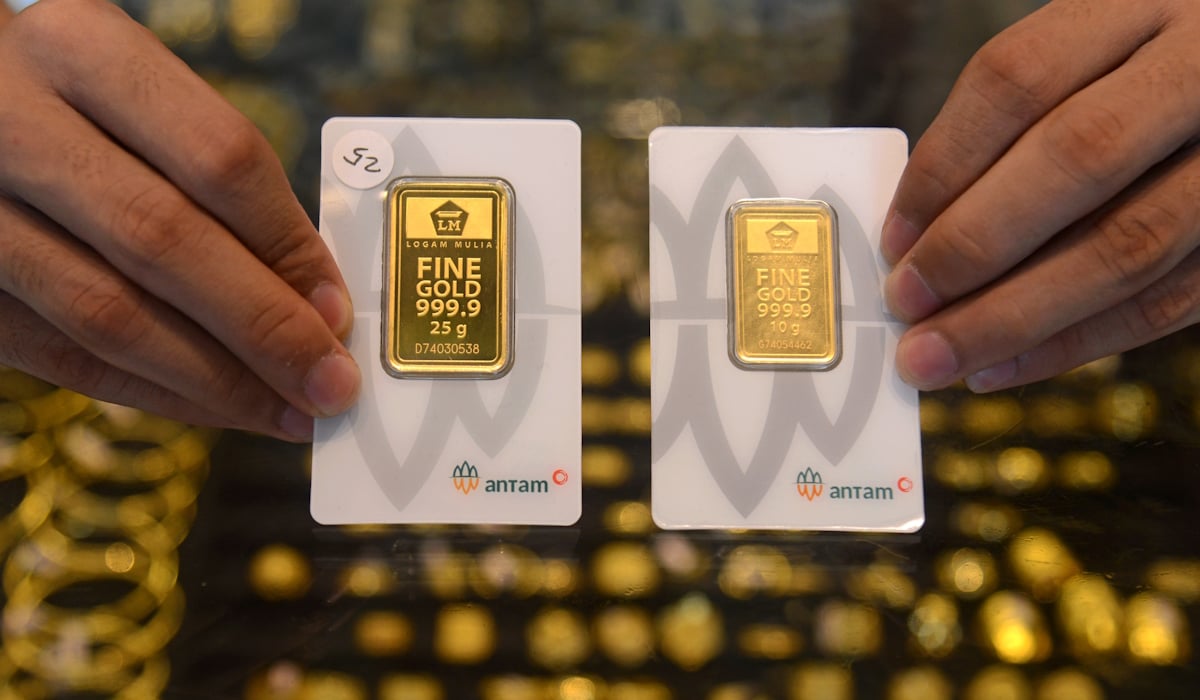 Pedagang memperlihatkan emas produksi PT Aneka Tambang Tbk (Antam)