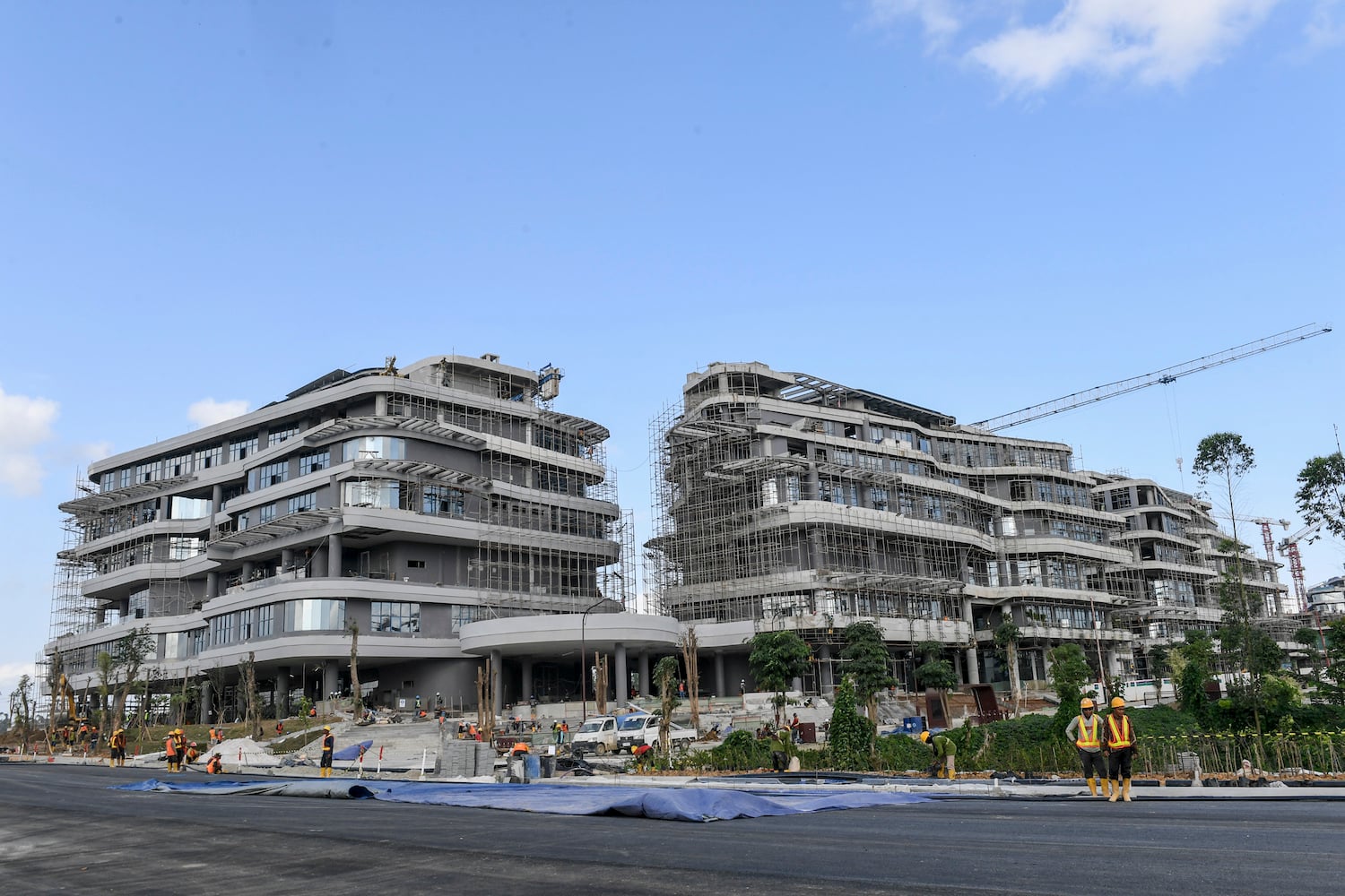 Pekerja menyelesaikan pembangunan gedung kantor kementerian koordinator di IKN